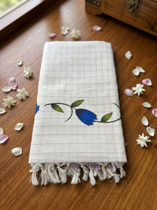Off-White Cotton Saree with Subtle Micro-Check Weave, Artisanal Blue Floral Vine Motifs, Pastel Lavender Pallu Accent, and Hand-Knotted Tassels