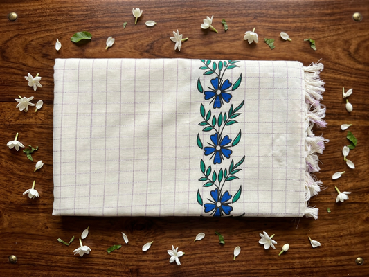 Off-White Cotton Saree with Lavender Micro-Checks, Artisanal Blue Floral Vine Motifs, Soft Purple Pallu Accent, and Hand-Knotted Tassels